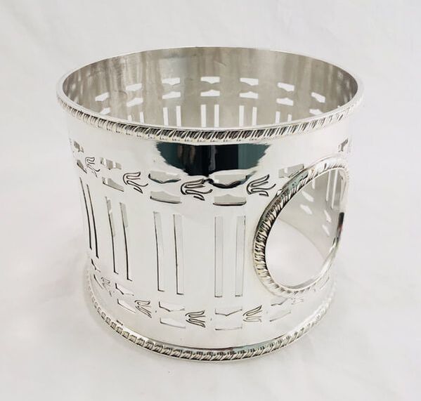 Close-up view of the restored silver plated vase holder, emphasizing the intricate details and polished finish.